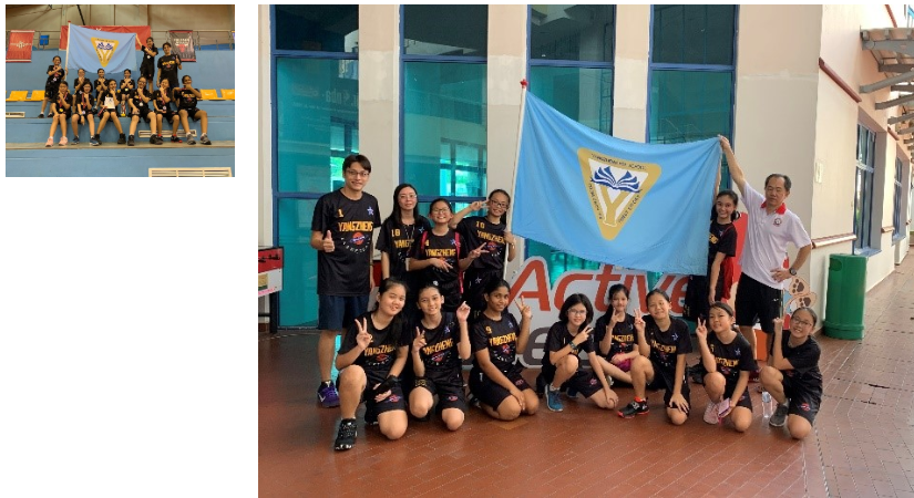 A group of primary school girls basketball players posing with their school flag
